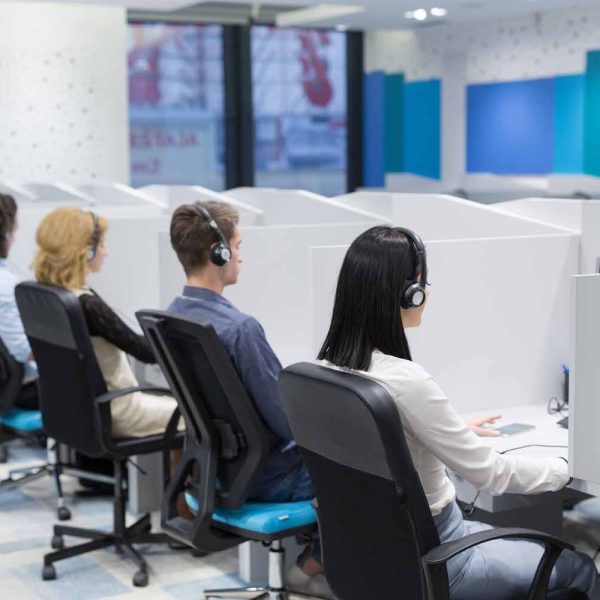 group of young business people with headset working and giving support to customers in a call center office